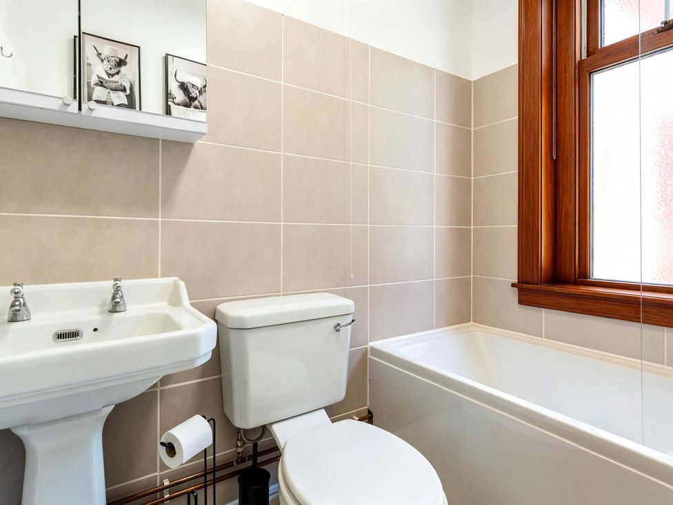 A bathroom with a sink, toilet, and bathtub at Fereneze, Lochranza, Isle Of Arran