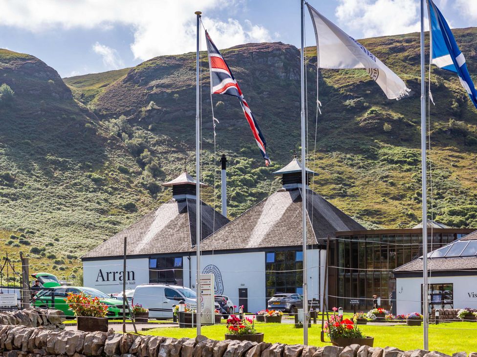 A building with flags and flowers at Fereneze in Lochranza, Isle Of Arran