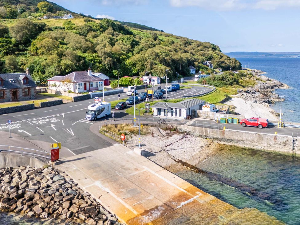 A coastal view with cars and buildings at Fereneze in Lochranza, Isle Of Arran