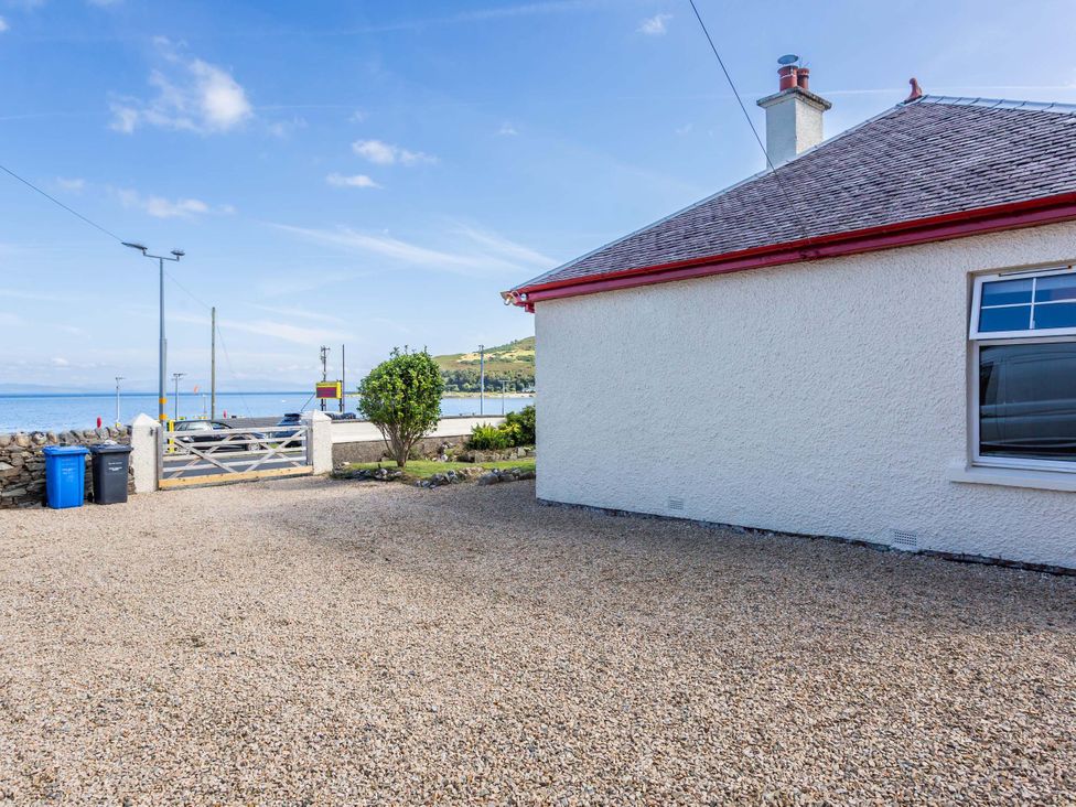 A house with a gravel area and a gate at Fereneze, Lochranza, Isle Of Arran