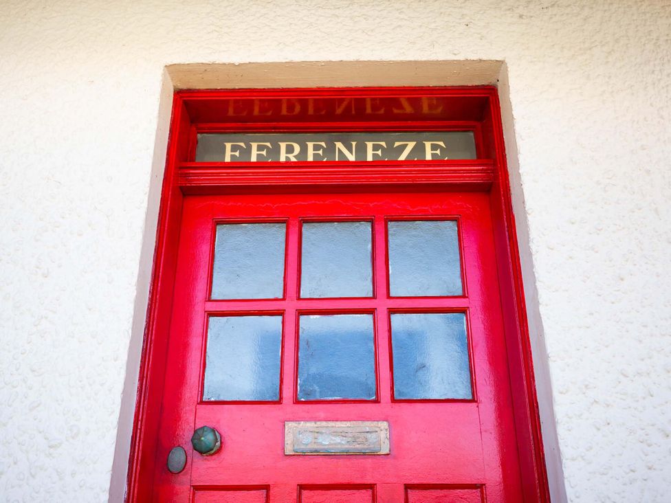 A red door with a nameplate reading Fereneze at Fereneze, Lochranza, Isle Of Arran