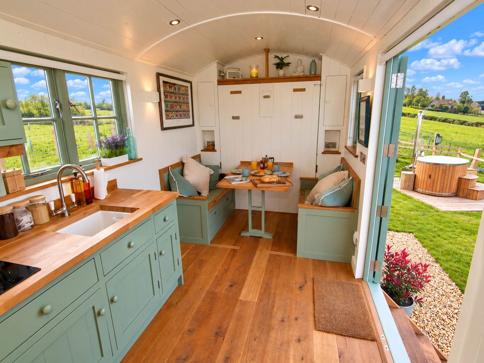 A kitchen with a table and chairs at Oak Hut in Bishops Castle