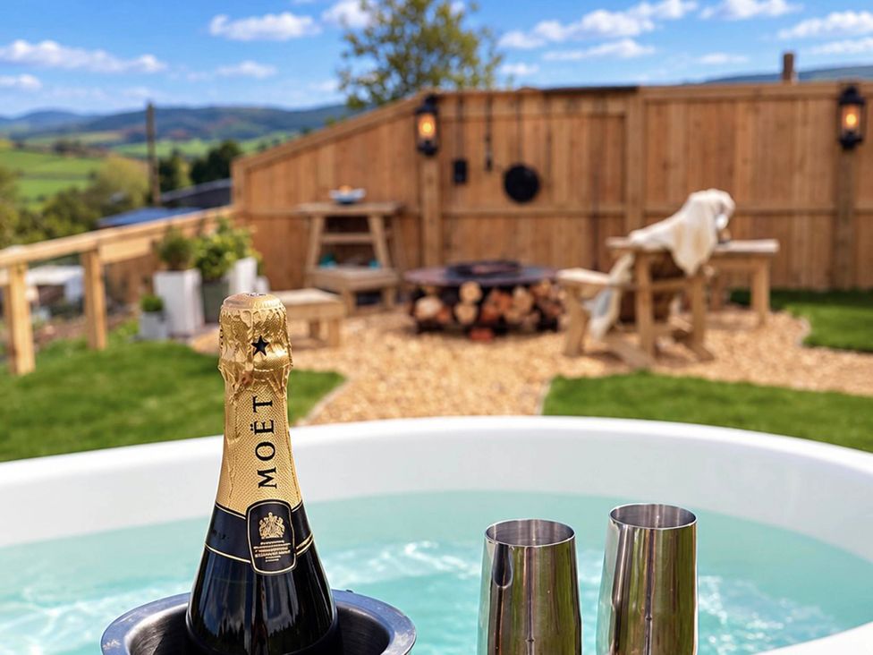 A garden with a champagne bottle in an ice bucket at Oak Hut in Bishops Castle