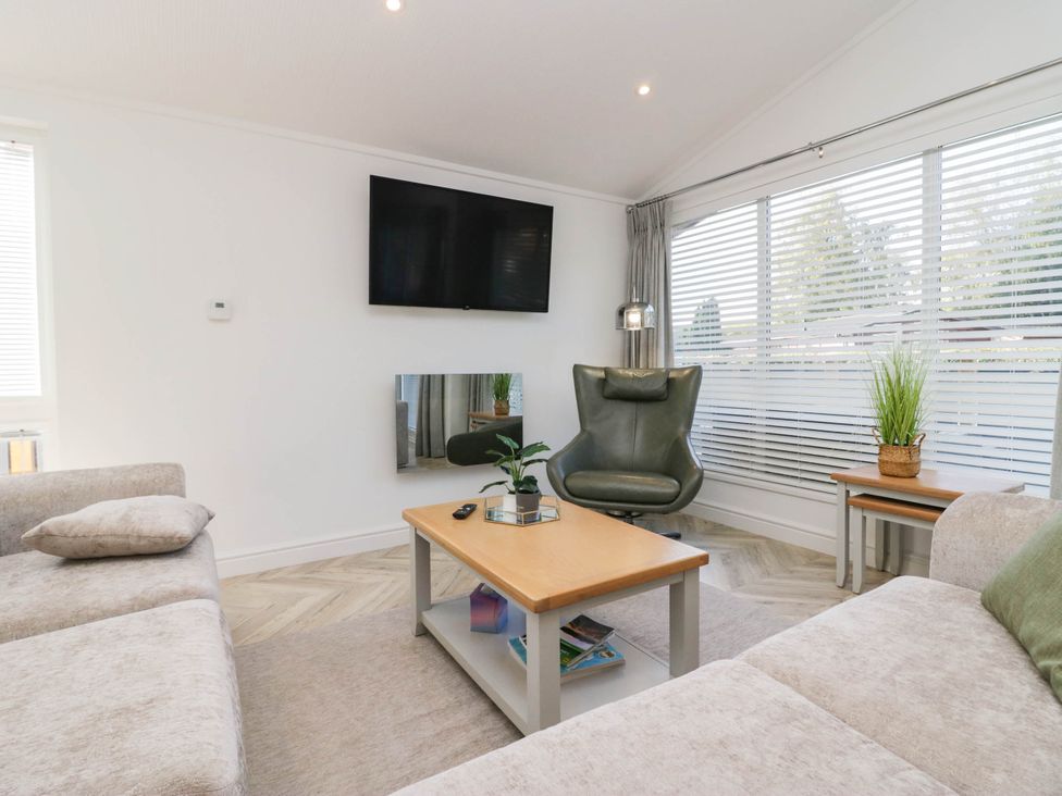 A living room with a sofa and coffee table at Thirlmere Scar in Troutbeck Bridge