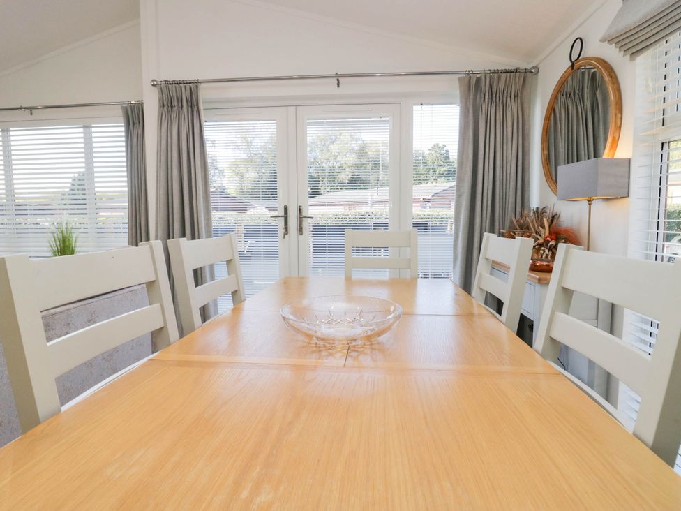 A dining room with a table and chairs at Thirlmere Scar in Troutbeck Bridge