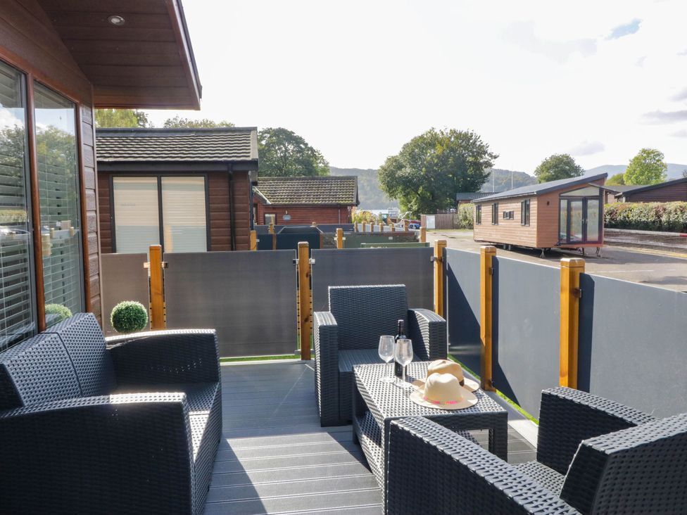 An outdoor seating area with chairs and table at Thirlmere Scar in Troutbeck Bridge