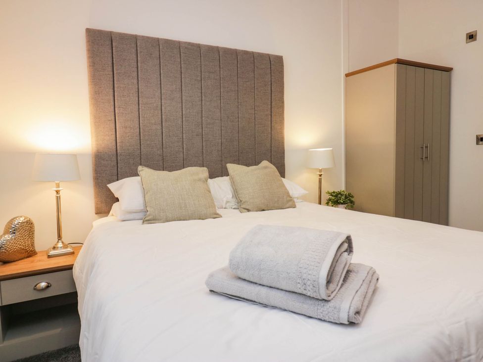 A bedroom with a bed and pillows at Thirlmere Scar in Windermere