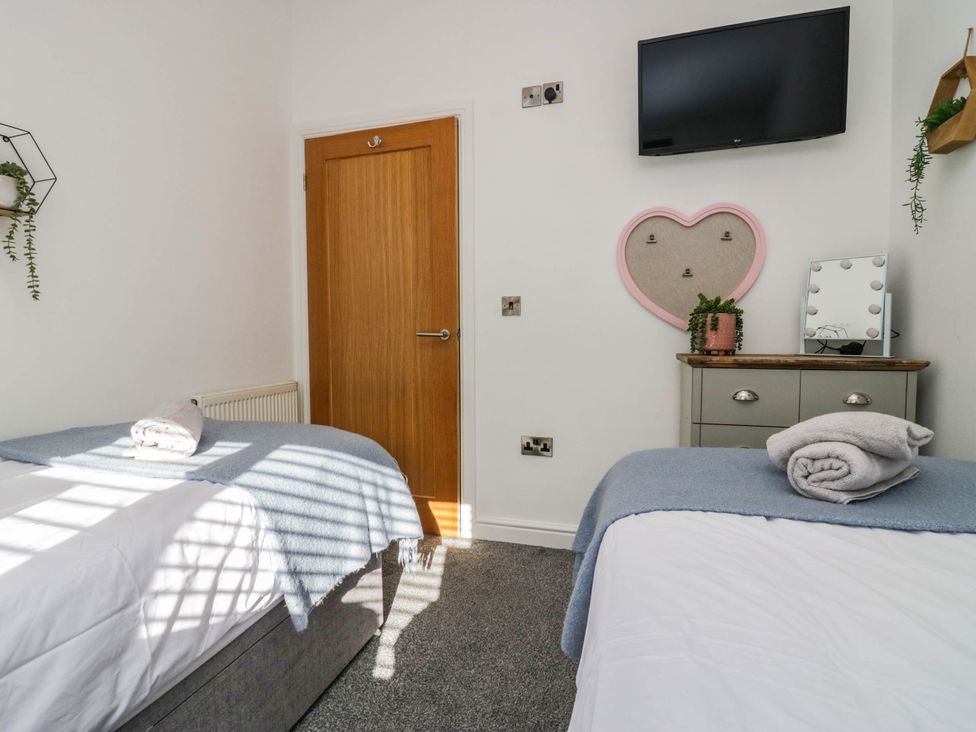 A bedroom with two beds and a television at Thirlmere Scar in Windermere