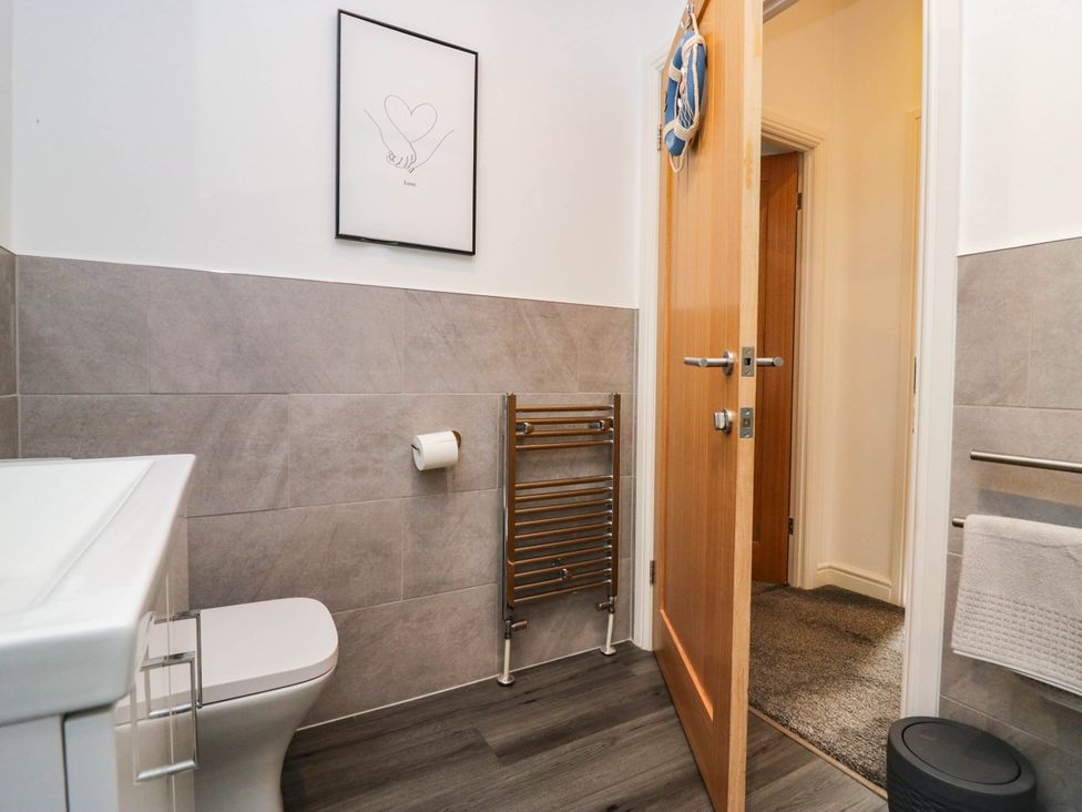 A bathroom with a toilet and towel rail at Thirlmere Scar in Windermere
