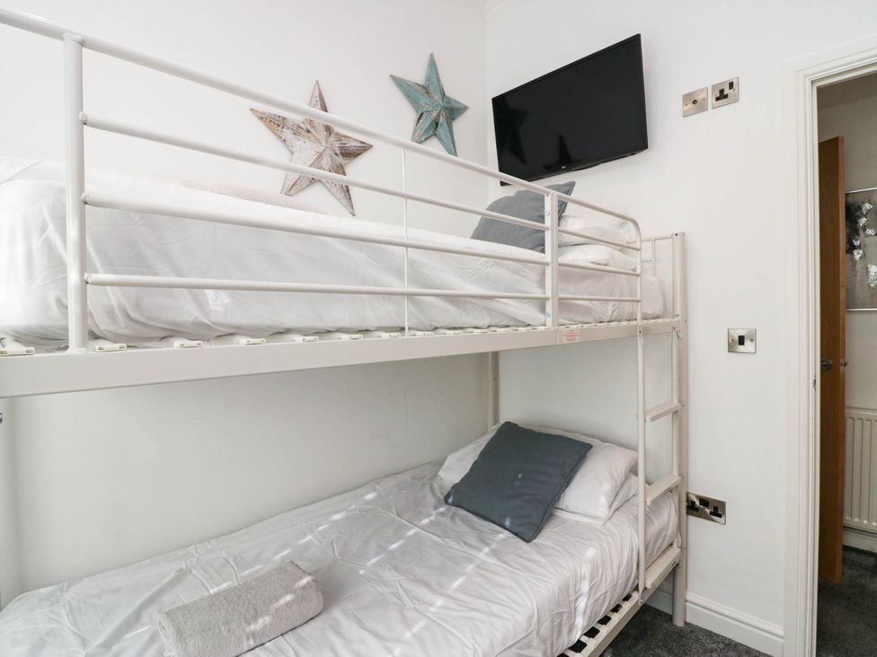 A bunk bed with a TV in a bedroom at Thirlmere Scar in Windermere
