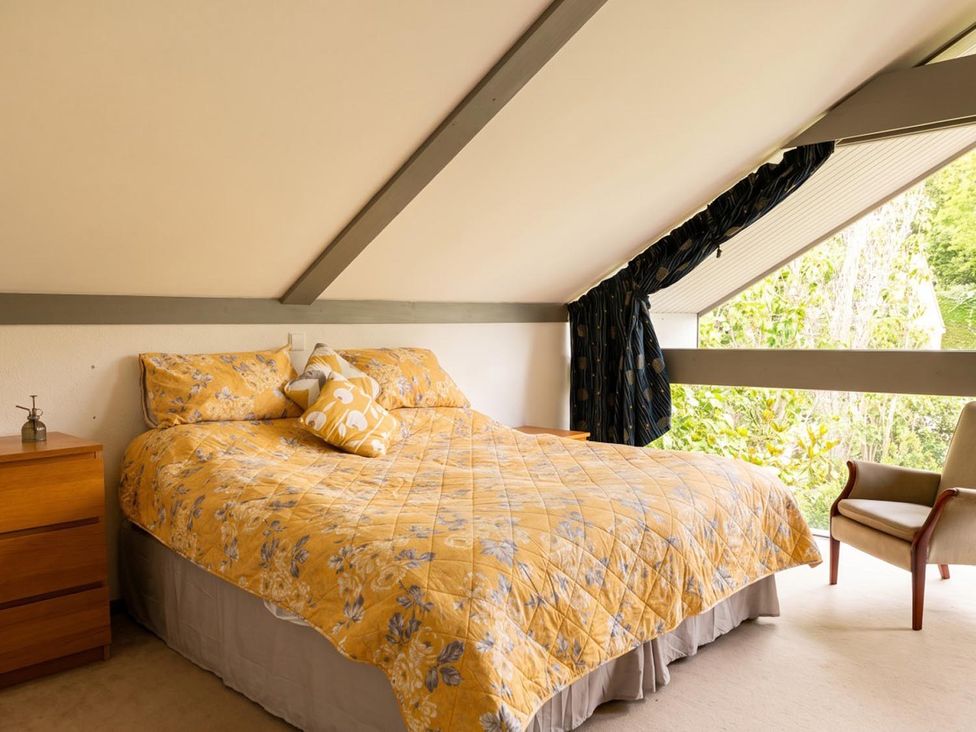 A bedroom with a bed and chair at Two Hoots Littleworth