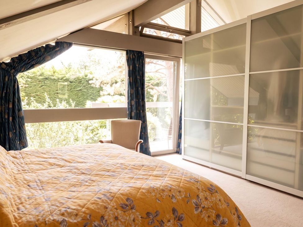 A bedroom with a bed and a sliding wardrobe at Two Hoots Littleworth
