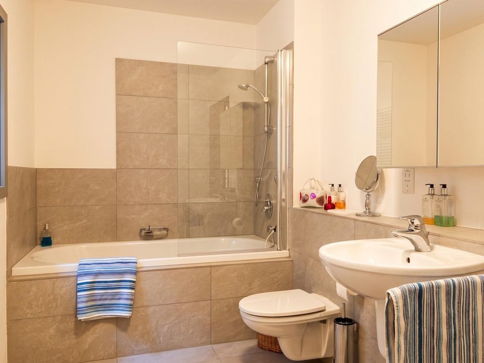 A bathroom with a bathtub and shower at Two Hoots Littleworth