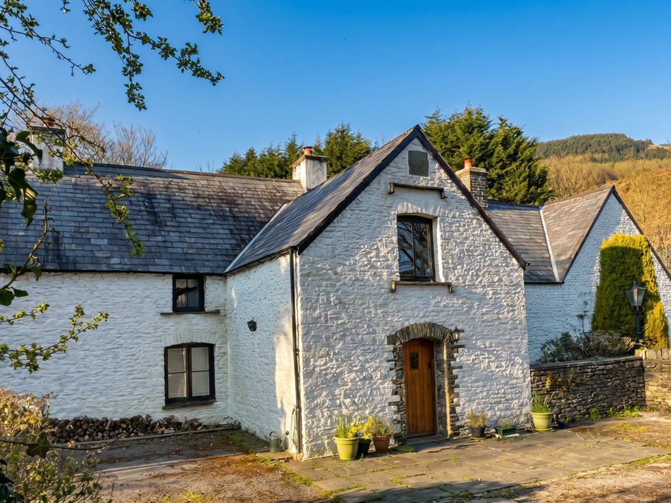 A house with a door and windows at Tynewydd Farmhouse