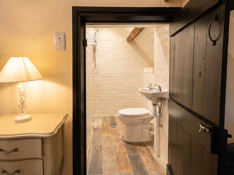 A bathroom with a sink and toilet at Tynewydd Farmhouse