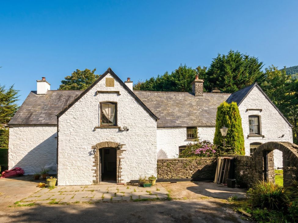 A house with a garden and pathway at Tynewydd Farmhouse 