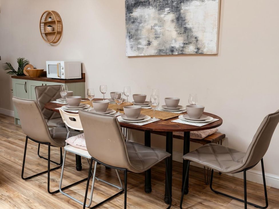 A dining room with a table set for dinner at The Old Barn in Manchester
