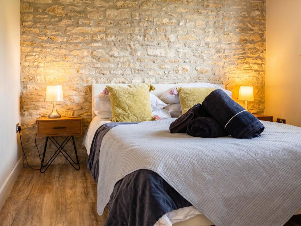 A bedroom with a bed and bedside lamps at The Old Barn in Manchester