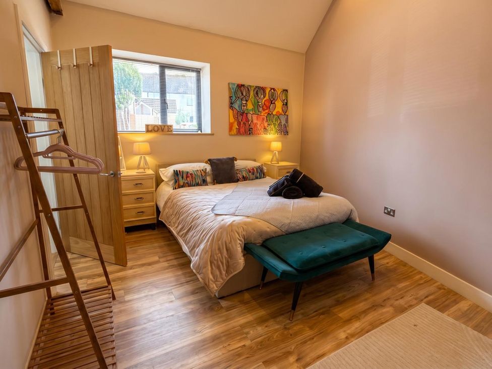 A bedroom with a bed and bedside tables at The Old Barn in Manchester