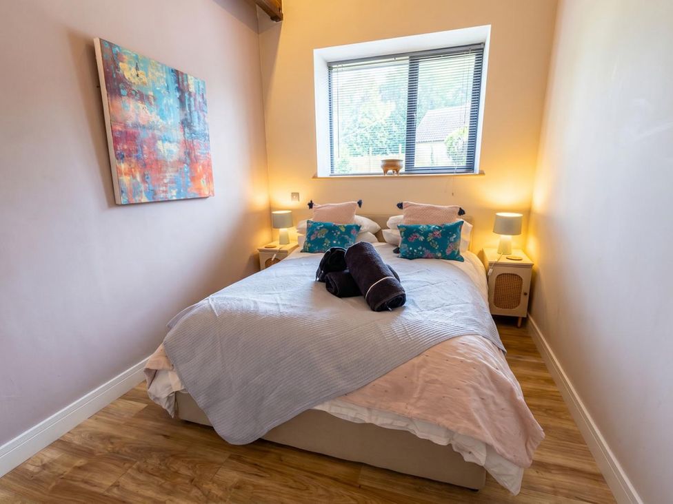 A bedroom with a bed and decorative pillows at The Old Barn in Manchester
