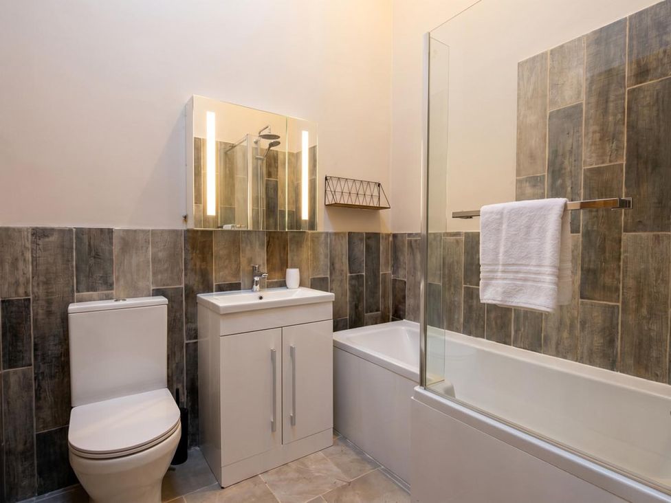 A bathroom with a sink, toilet, bathtub, and shower at 