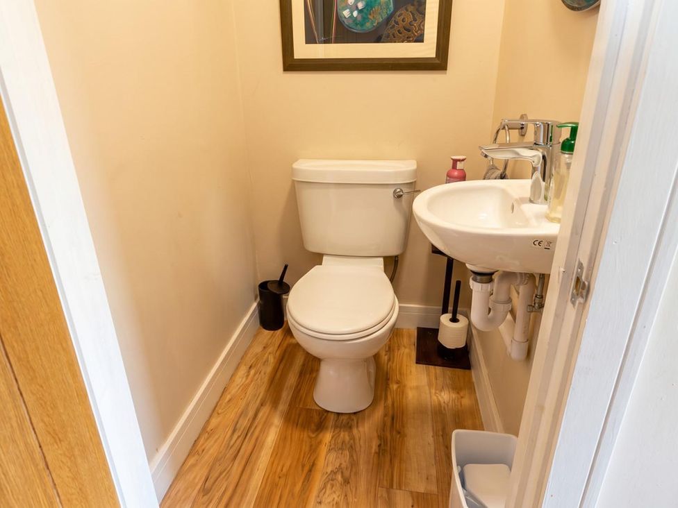 A bathroom with a toilet and sink at the property in location