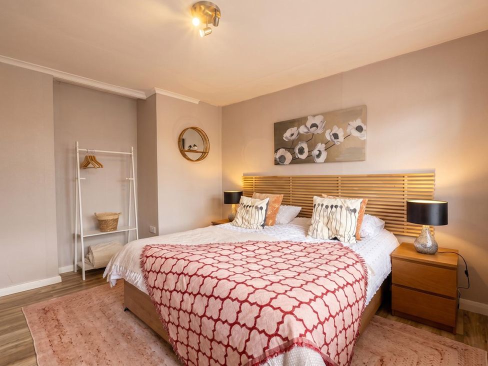A bedroom with a bed and bedside tables at 