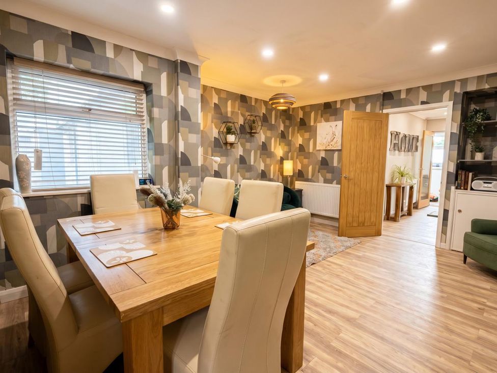 A dining room with a table and chairs at 