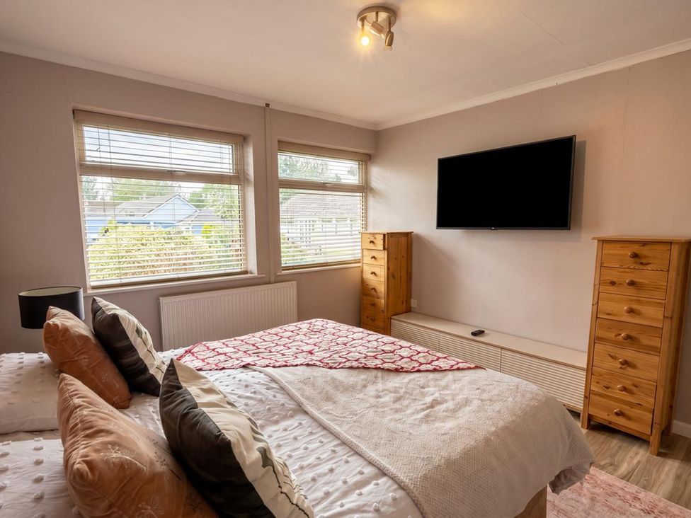 A bedroom with a bed and television at a property