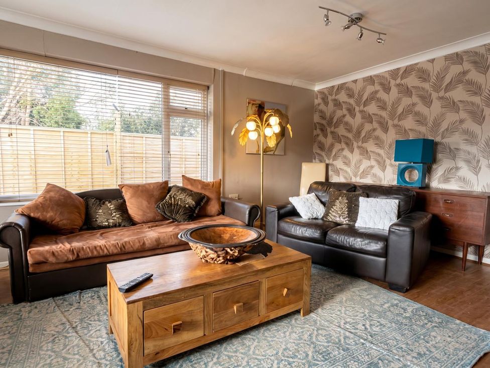 A living room with sofas and a coffee table at The Old Barn in Manchester