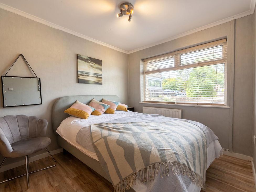 A bedroom with a bed and a chair at the property in an undisclosed location