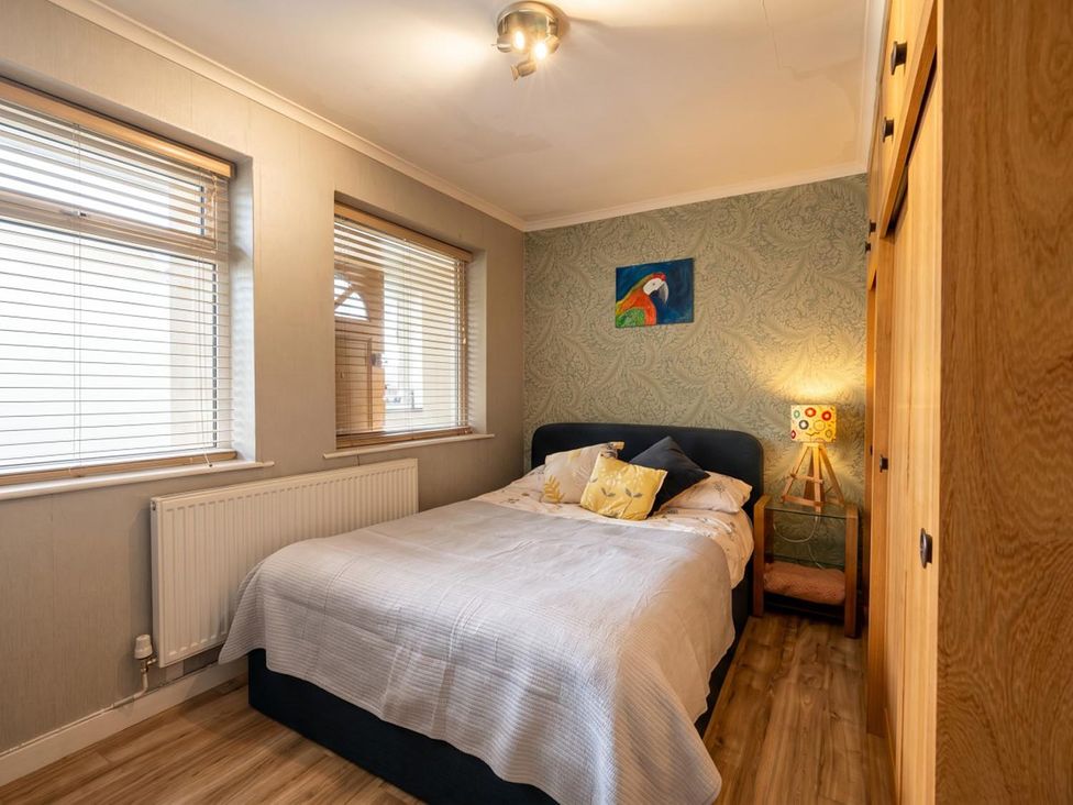 A bedroom with a bed and a wardrobe at the property