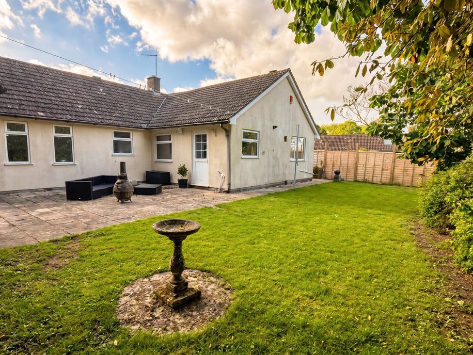 A garden with seating area and birdbath at The Old Barn in Manchester