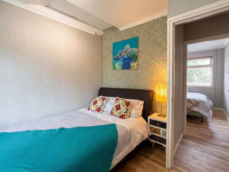 A bedroom with a bed and bedside table at The Old Barn in Manchester