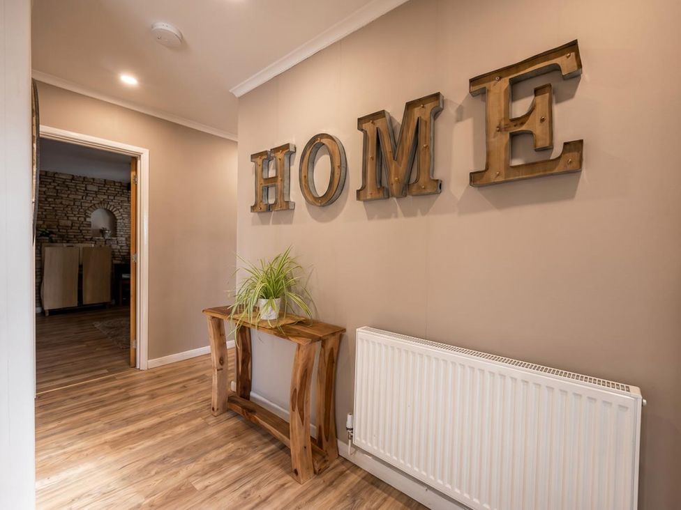 A hallway with wooden letters and a table at the property