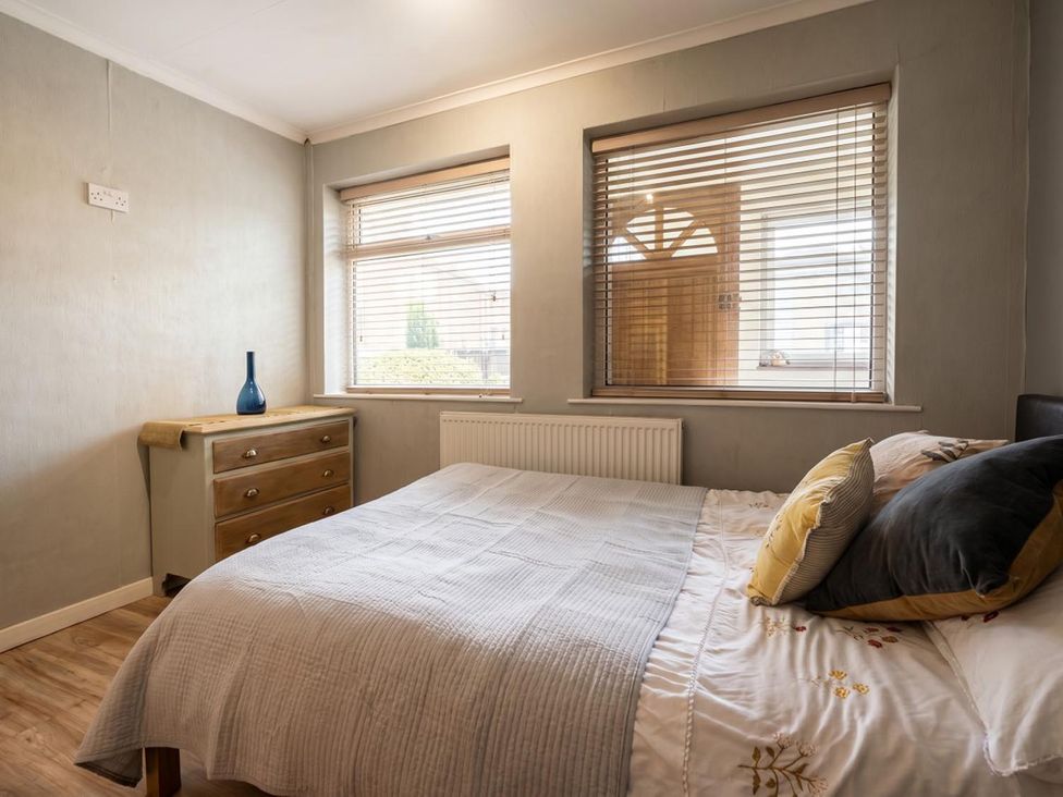 A bedroom with a bed and a dressing table at The Old Barn in Manchester