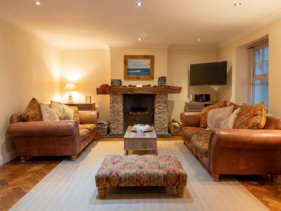 A living room with sofas and a fireplace at The Old Barn in Manchester