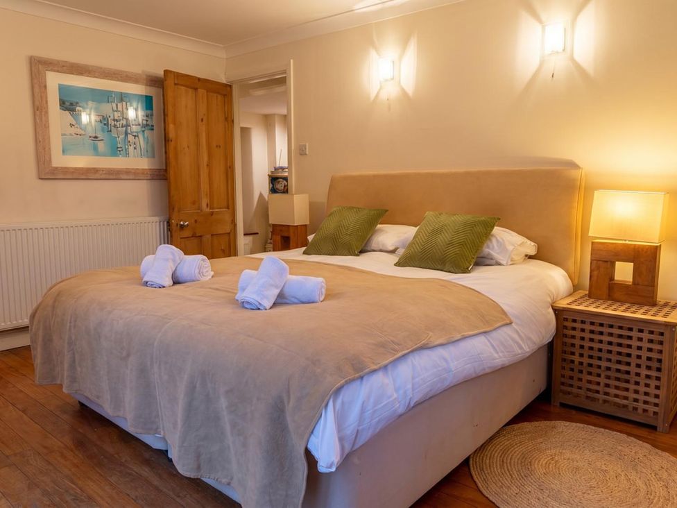 A bedroom with a bed and artwork at The Old Barn in Manchester