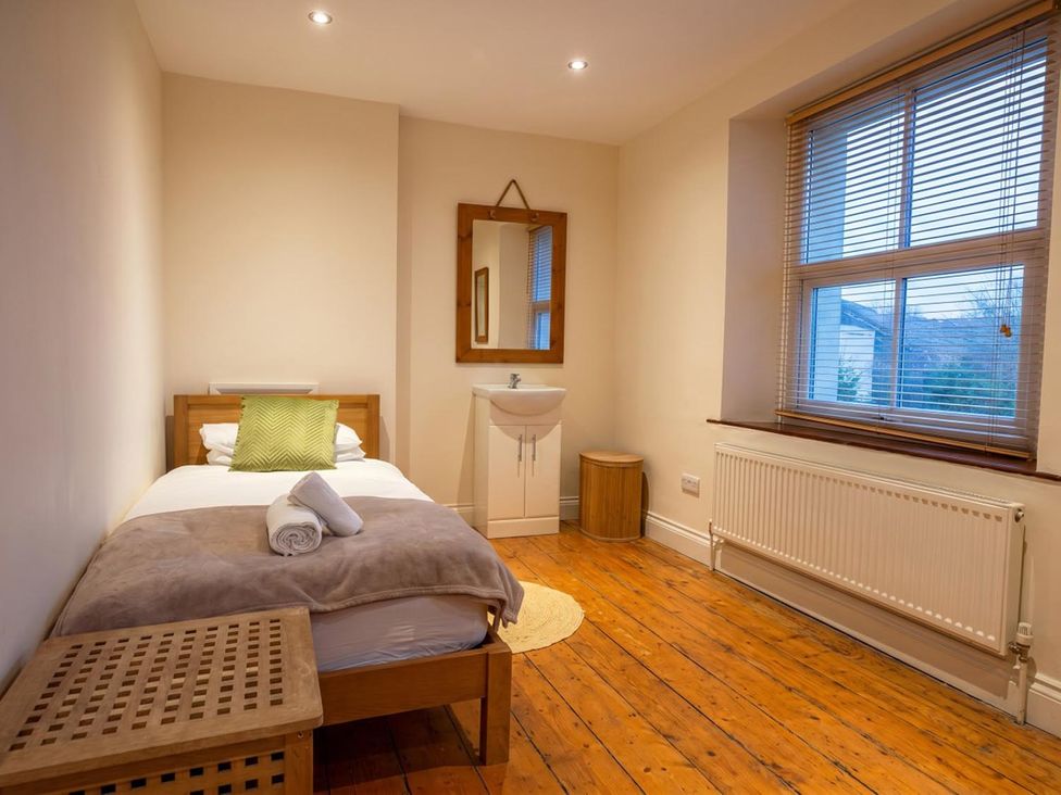 A bedroom with a bed and a sink at the property in a location