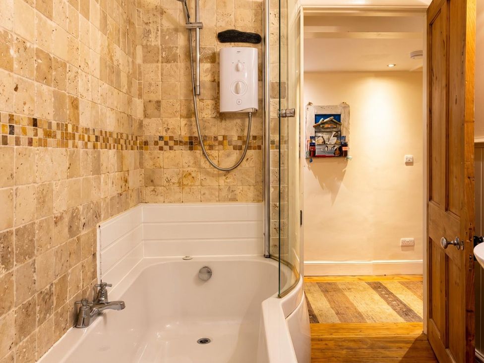A bathroom with a bathtub and shower at The Old Barn in Manchester
