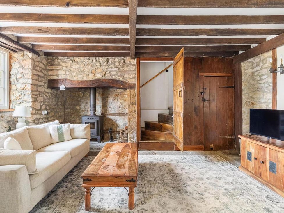 A living room with a sofa and wooden coffee table at the property in location