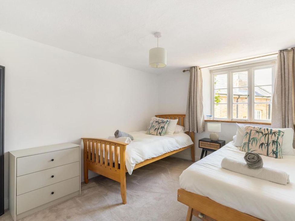 A bedroom with two beds and a dresser at the property in the location