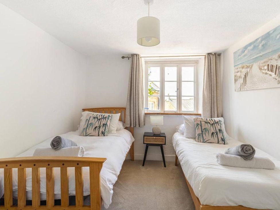 A bedroom with two beds and a window at The Old Barn in Manchester
