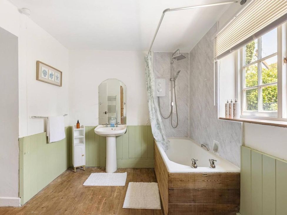 A bathroom with a bath tub and sink at The Old Barn in Manchester