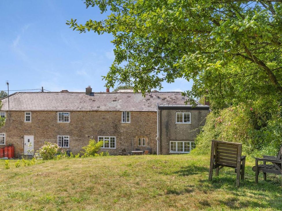 A garden with a house in the background at The Old Barn in Manchester
