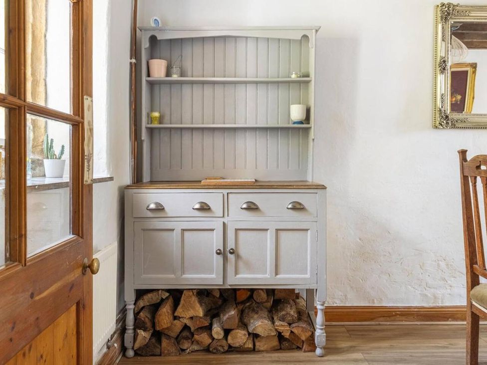 A cabinet with shelves and wooden logs at a dining room