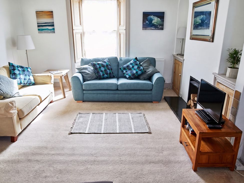 A living room with a blue sofa and coffee table at The Old Barn in Manchester