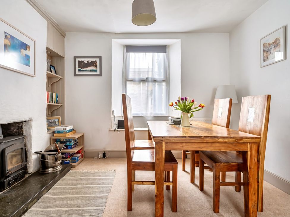 A dining room with a wooden table and chairs at The Old Barn in Manchester