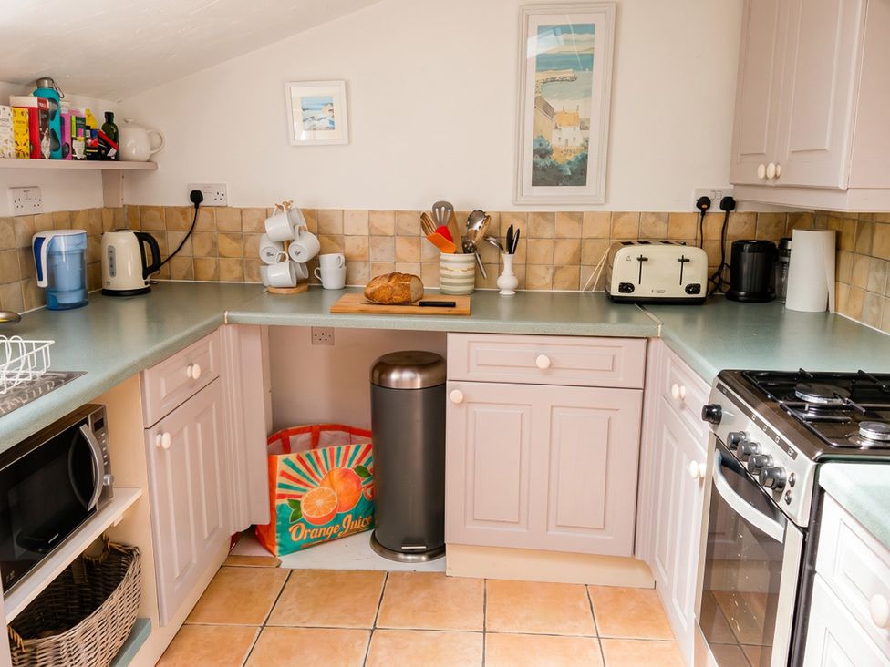 A kitchen with appliances and utensils at a property