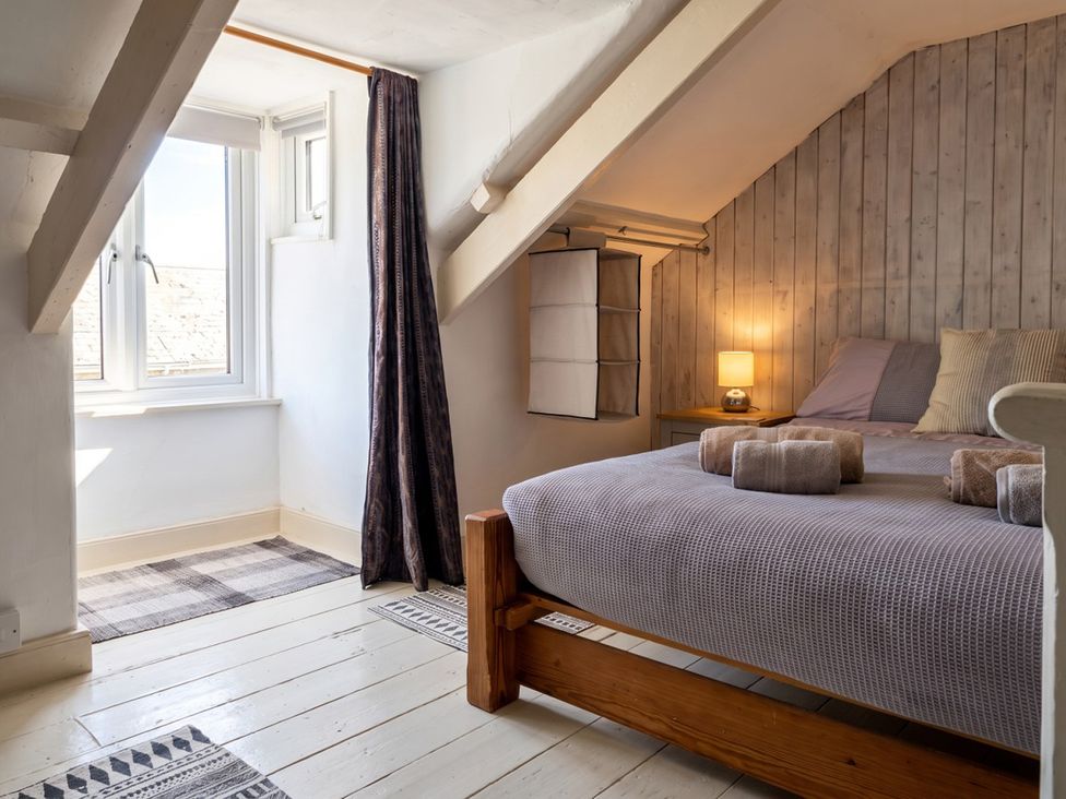 A bedroom with a bed and window at The Old Barn in Manchester
